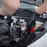 Car detailing maintaince, cleaning engine with the foam and a brush